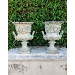 A pair of Handyside foundry cast iron urns