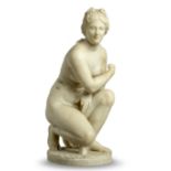 After the antique: A carved alabaster figure of the crouching Venus