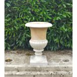 A similar single carved white marble urn