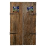 A pair of elm wood doors with inset leaded stained glass panels