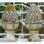 A pair of carved limestone pineapple finials