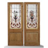 A pair of pine doors set with stained glass panels