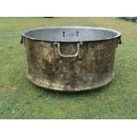 † A large beaten brass pot