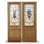 A similar pair of pine doors with stained glass panels