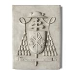 A similar carved white marble papal coat of arms plaque