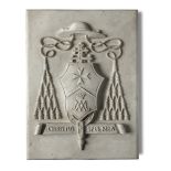 A carved white marble papal coat of arms plaque