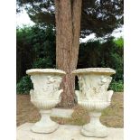 A pair of composition stone urns