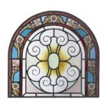 A stained glass arched panel