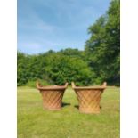 A pair of terracotta basket weave planters