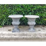 A pair of grey veined marble urns