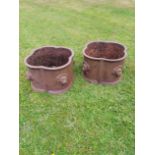 A pair of cast iron lobed planters