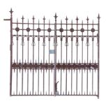 A pair of unusual wrought and cast iron bi-folding gates