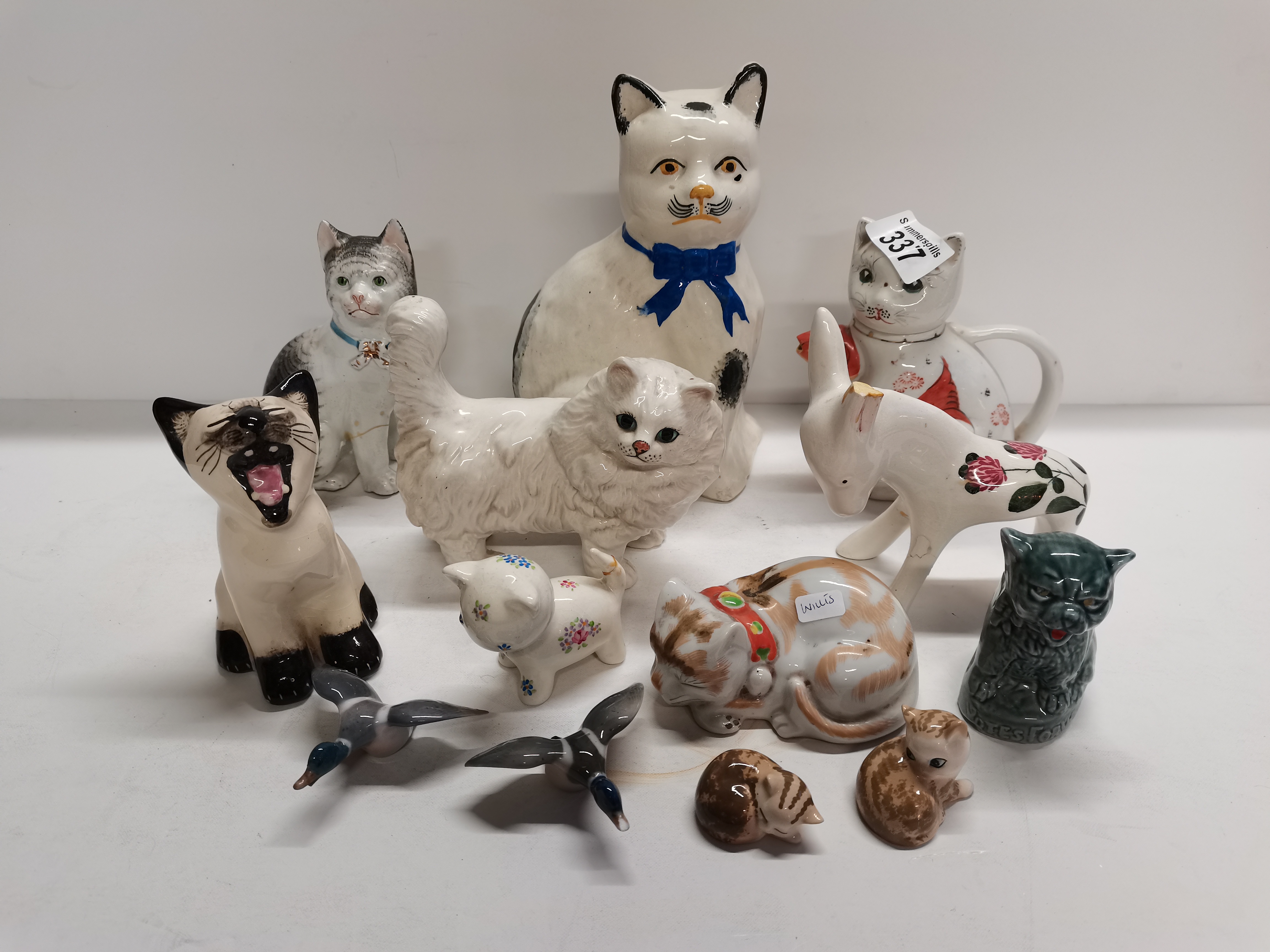 13 Pieces of Pottery 10 cats 2 ducks and a donkey Including 1 Beswick Cat (Damaged Ear to Donkey)
