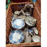 Wicker picnic basket with blue and white china tea set