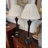 A pair of table lamps with cream shades