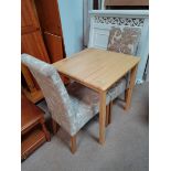 Square table with 2 cream upholstered dining chairs