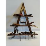 Triangular wooden wall mounted corkscrew stand complete with 18 different corkscrews. H57cm x