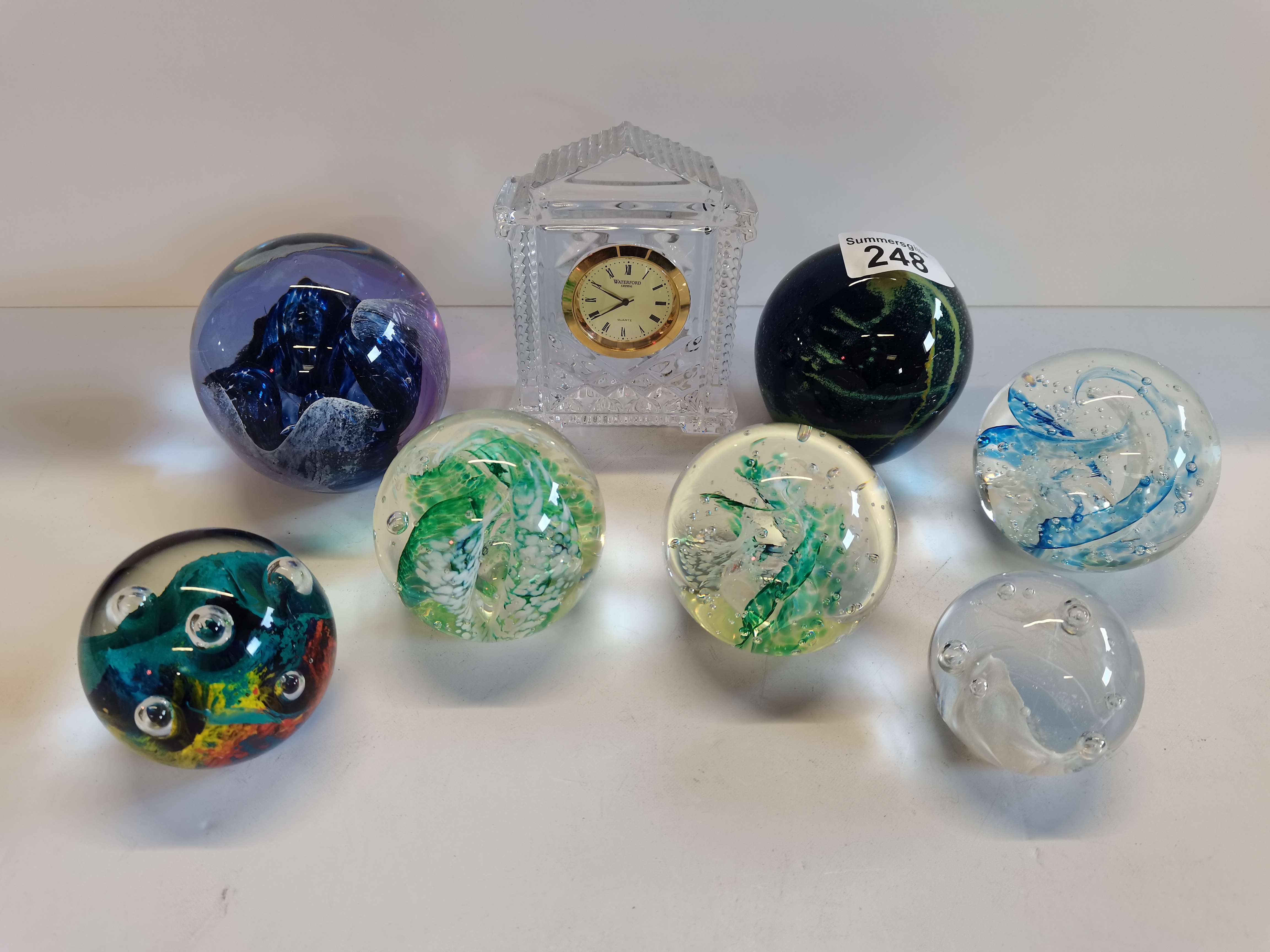 X7 glass paperweights and a glass mantle clock