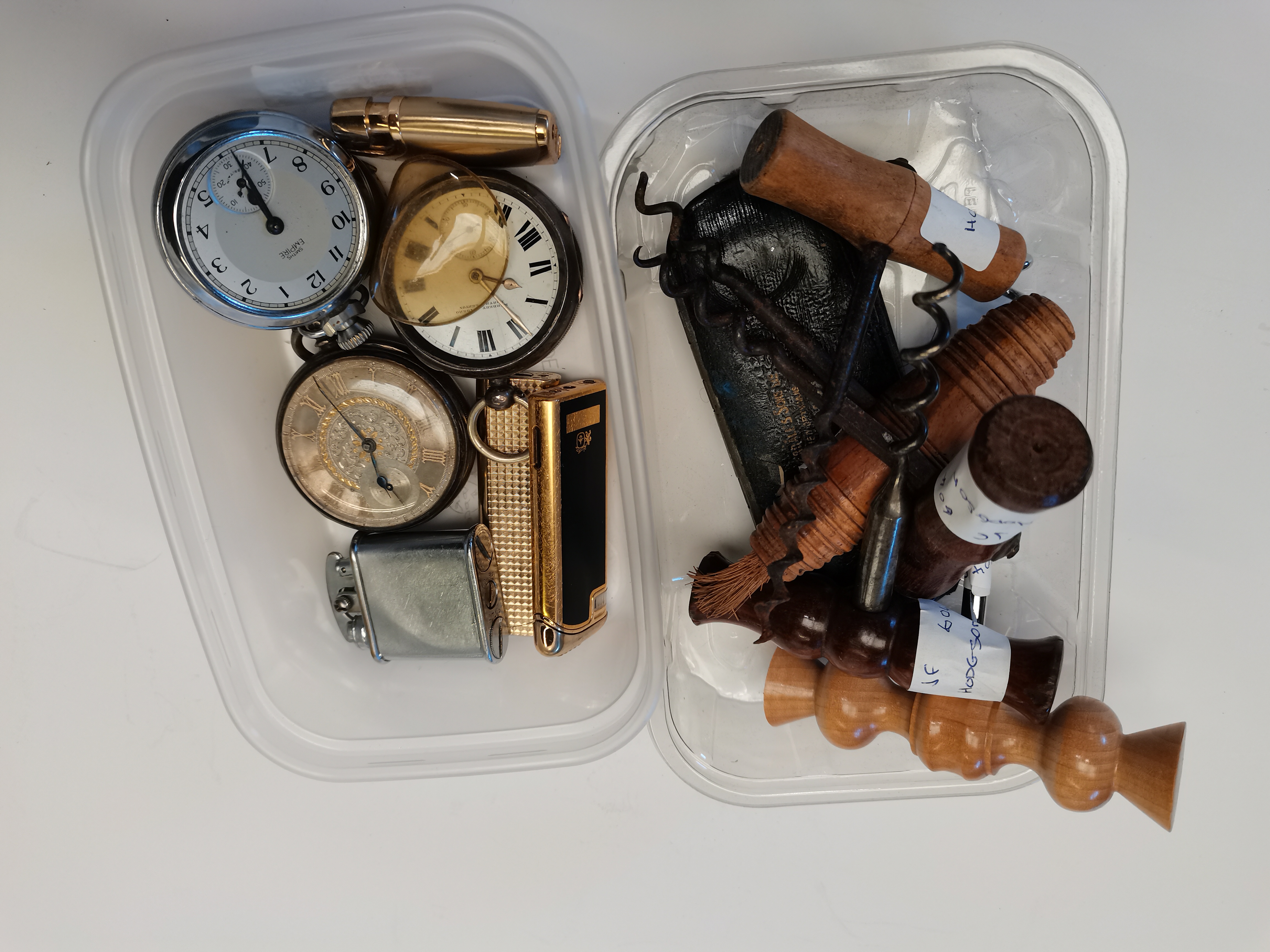 collection of corkscrews and pocket watches and lighter