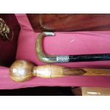 x2 Walking sticks, (1) Tapered ebonised shaft with silver repousse mounts and horn handle. (2)