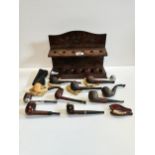 A selection of pipes and wooden pipe stand