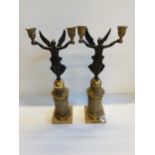 A Pair of French Empire style gilt candle sticks with cherub decoration