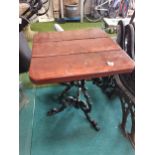 Square table with wrought iron tri-pod base