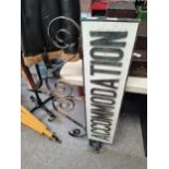 Old "Accommodation" sign with wrought iron surround