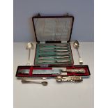 set of silver butter knives, sugar tongs and stainless steel and sterling silver bread knife.