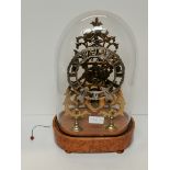 Antique Skeleton Mantle clock on a birds eye maple stand. height 39cm ex condition.