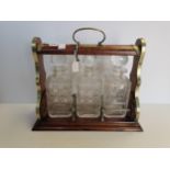 Wooden Tantalus with key - brass detailing and 3 cut glass decanters