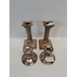 A pair of silver 14cm corinithian candlesticks Sheffield and another smaller pair Birmingham