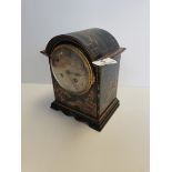 Oriental wooden mantle clock with various scenes and key