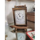 French brass carriage clock marked R and C with key plus a brass Walter Bosse bottle opener in shape