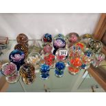 A collection of various glass paperweights