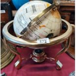 Cream globe on brass stand with compass in the base