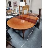 Mahogany dining table with 3 leaves. On Castors.