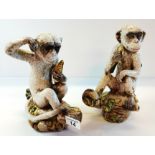 A pair of ceramic monkeys repro.