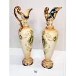 A pair of Crown Devon claret jugs with cherub deco ex condition