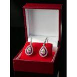 A PAIR OF 18CT WHITE GOLD, RUBY AND DIAMOND DROP EARRINGS Set with a central pear shape diamond