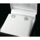 A PAIR OF 18CT WHITE GOLD AND BRILLIANT CUT DIAMOND STUDS Four claw setting, boxed. (approx diamonds