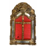 AN 18TH CENTURY CONTINENTAL IVORY CRUCIFIX SET IN A CARVED GILTWOOD FRAME Decorated with flowerheads