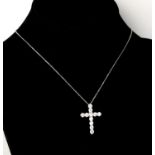 AN 18CT WHITE GOLD AND DIAMOND CROSS ON A SILVER CHAIN Boxed. (approx diamonds 2.25ct)