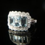 AN 18CT WHITE GOLD, AQUAMARINE AND DIAMOND RING The three aquamarine gemstones surrounded by