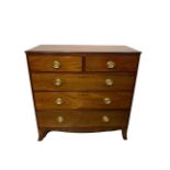 A GEORGIAN MAHOGANY CHEST With two short above three long drawers fitted with oval brass loop