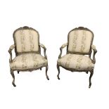 A PAIR OF 19TH CENTURY FRENCH CARVED WOOD AND PAINTED OPEN ARMCHAIRS The shaped back and scrolling