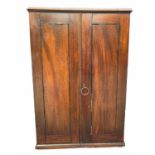 AN EARLY 19TH CENTURY MAHOGANY TABLE TOP COLLECTOR'S CABINET The panel doors opening to reveal a