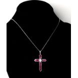 AN 18CT WHITE GOLD, DIAMOND AND RUBY CROSS Boxed. (approx rubies 3.33ct, diamond 0.17ct)