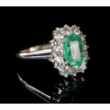 AN 18CT WHITE GOLD, NATURAL EMERALD AND DIAMOND CLUSTER RING. (emerald approx 1.40ct, size O)