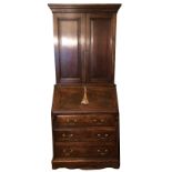 AN 18TH CENTURY DESIGN OAK BUREAU BOOKCASE The two fielded panelled doors above a fall front